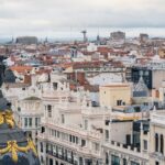 A captivating view of Madrid's iconic Metropolis Building amidst historic rooftops.